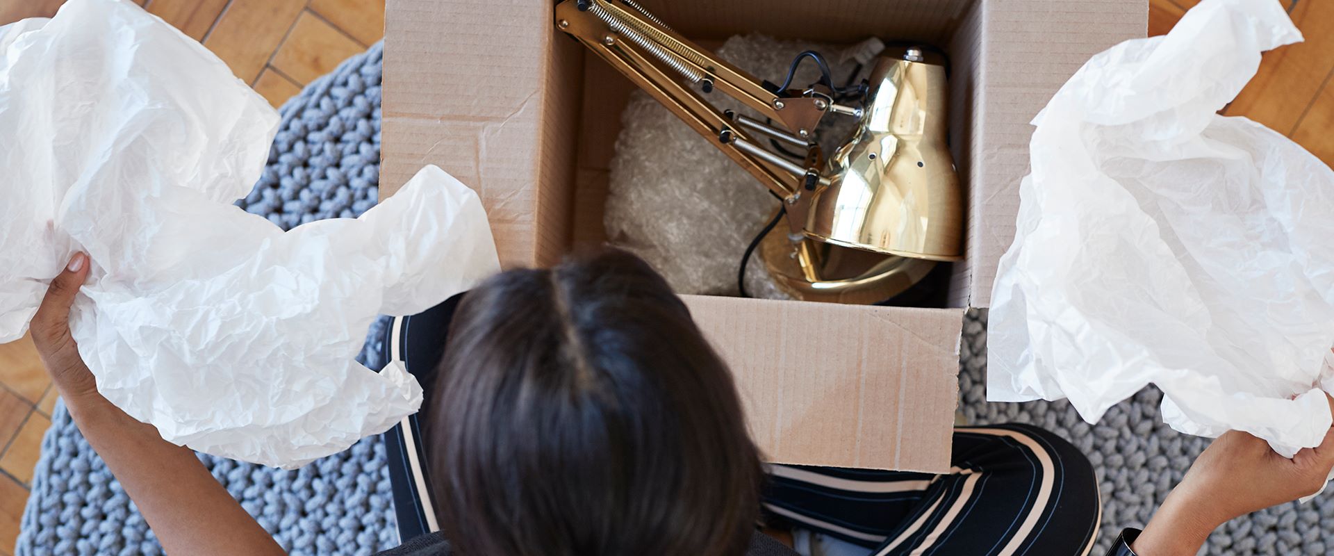 woman unboxing a lamp