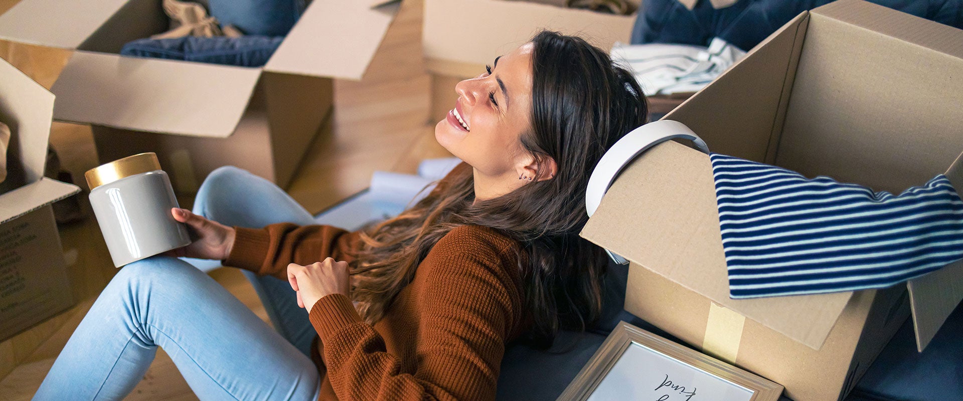 woman laughing next to boxes