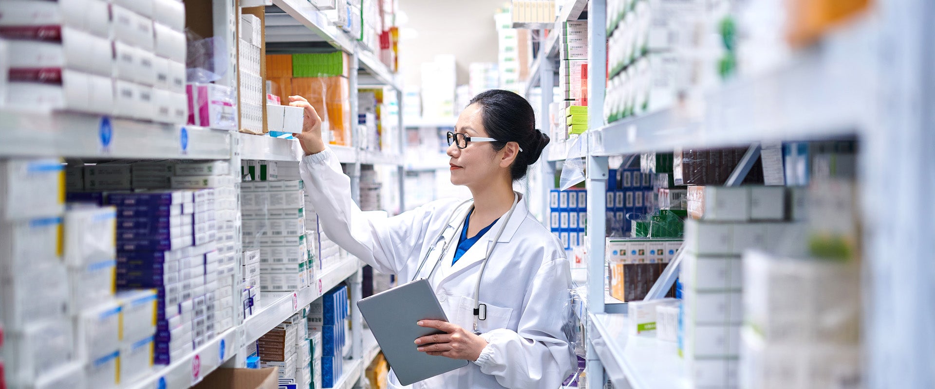 pharmacist choosing perscription from a shelf