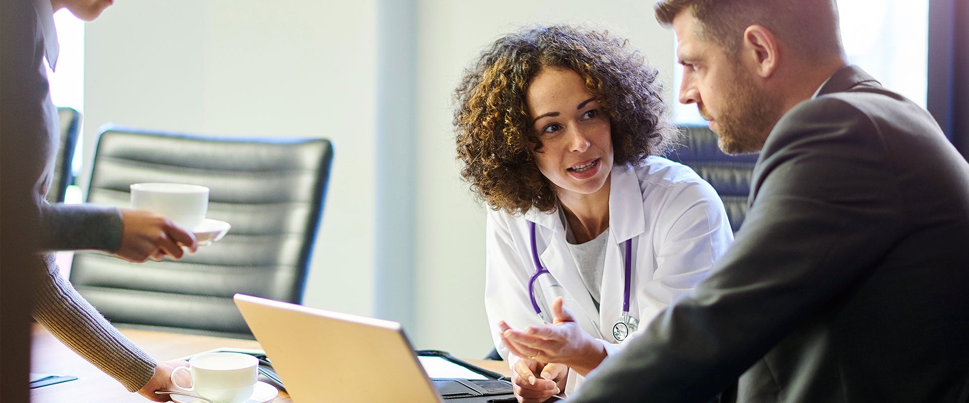 doctor talking to person in suit