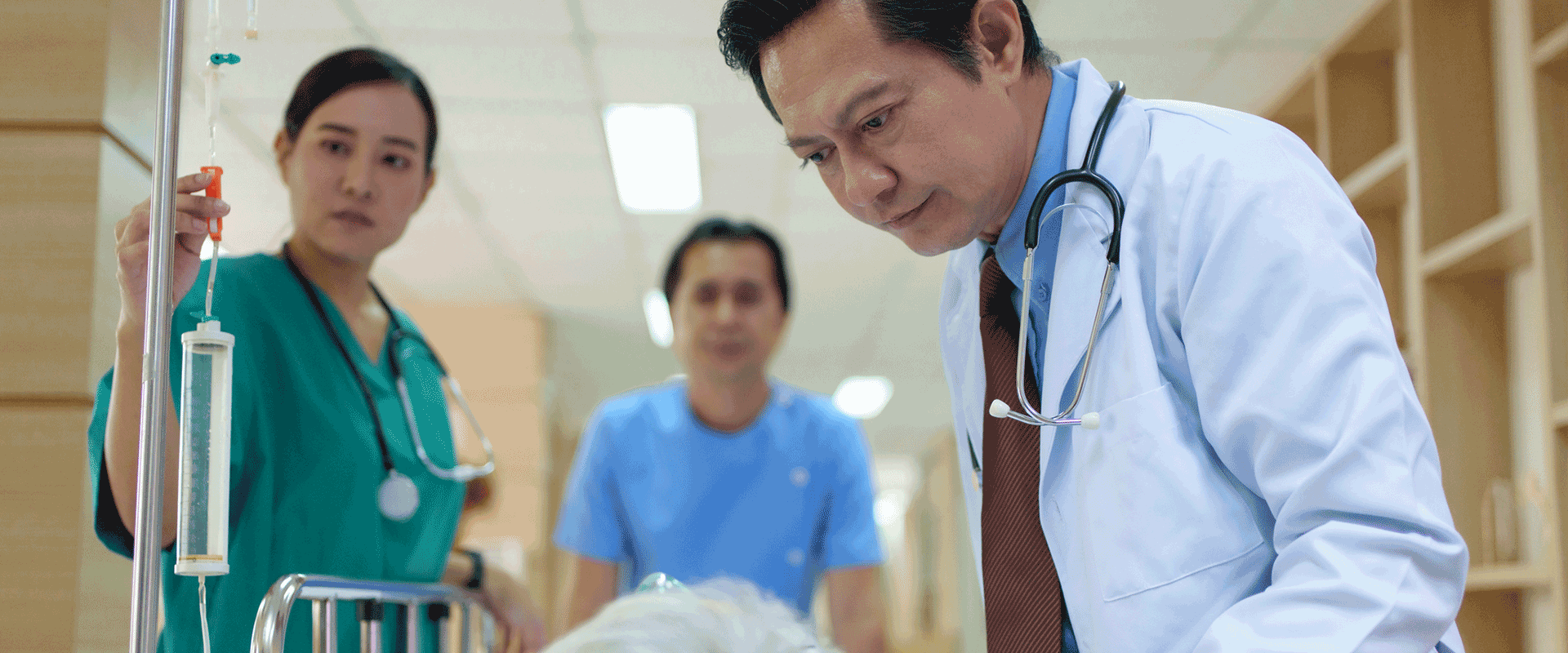 doctor looking at patient in hospital bed