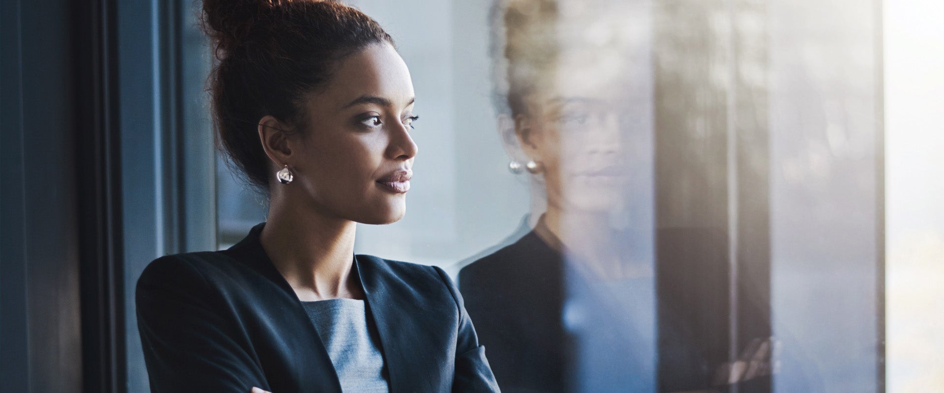 Business woman looking out office window