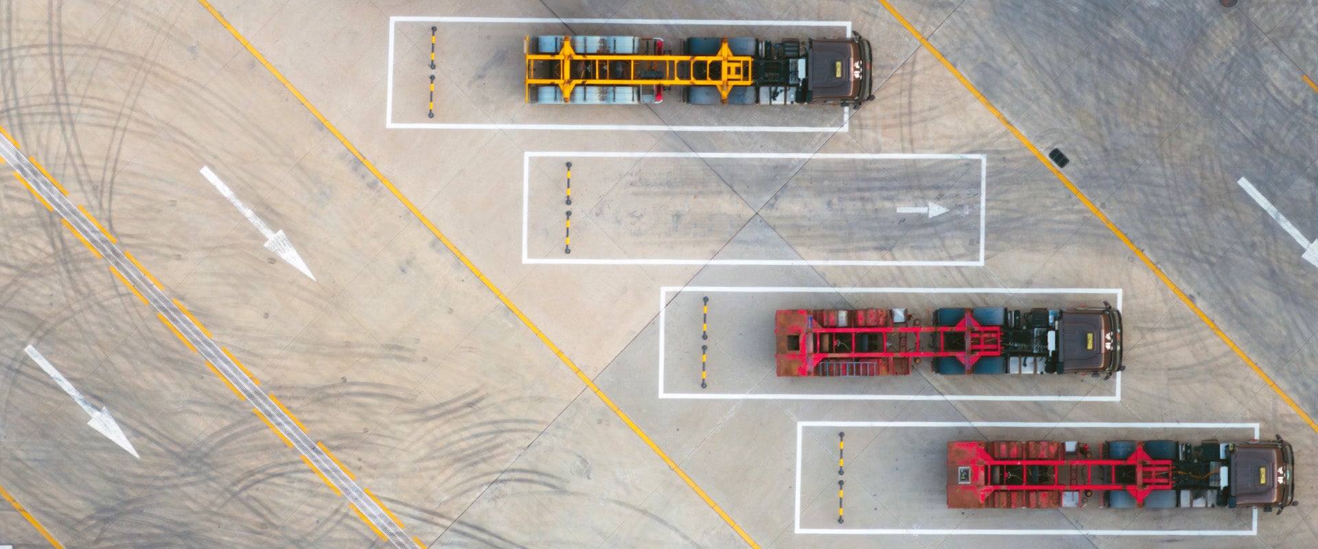 Transport trucks parked waiting to be loaded with containers