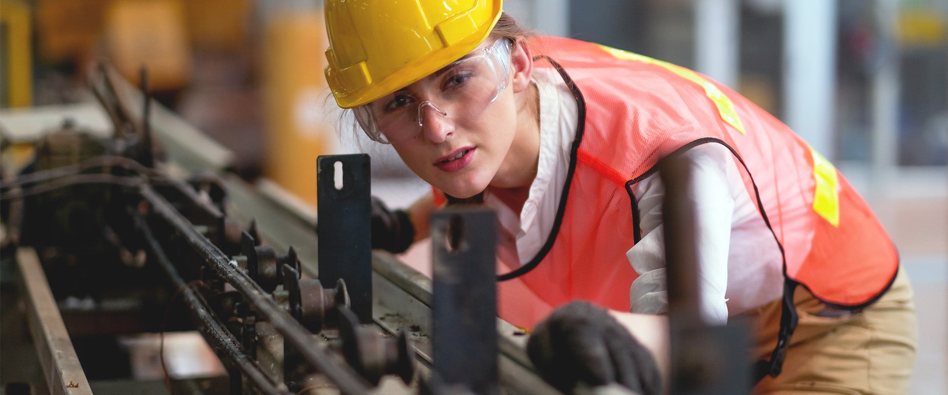 worker examining assembly line