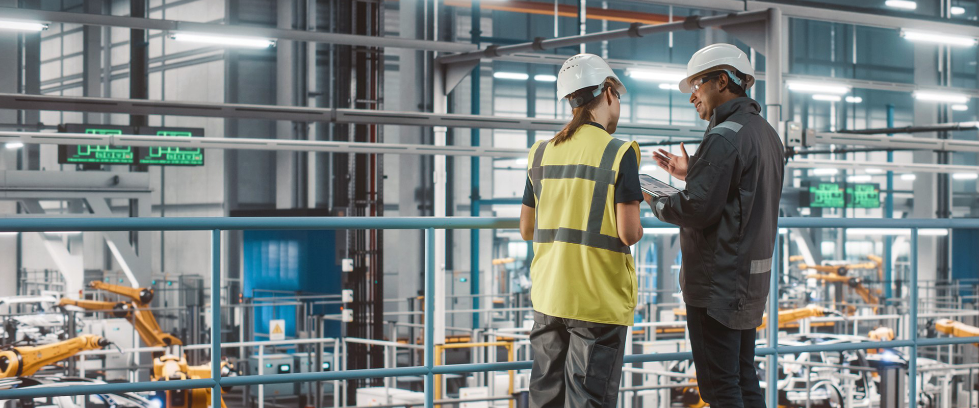 industrial worker and man in suit in factory