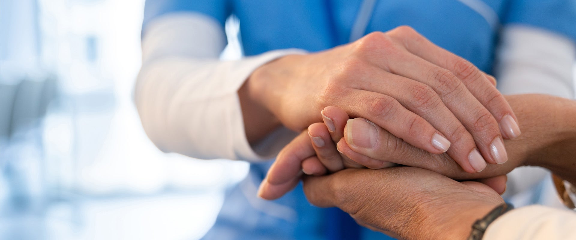 medical professional holding patient's hands