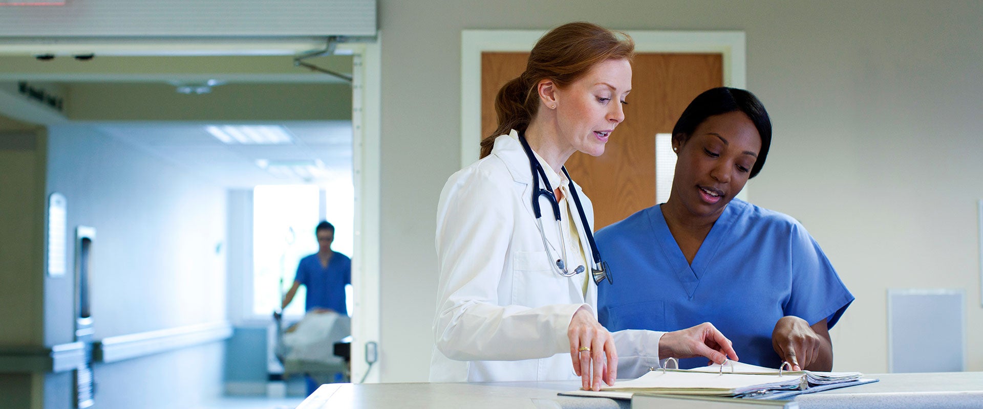 doctor talking to nurse in a hospital