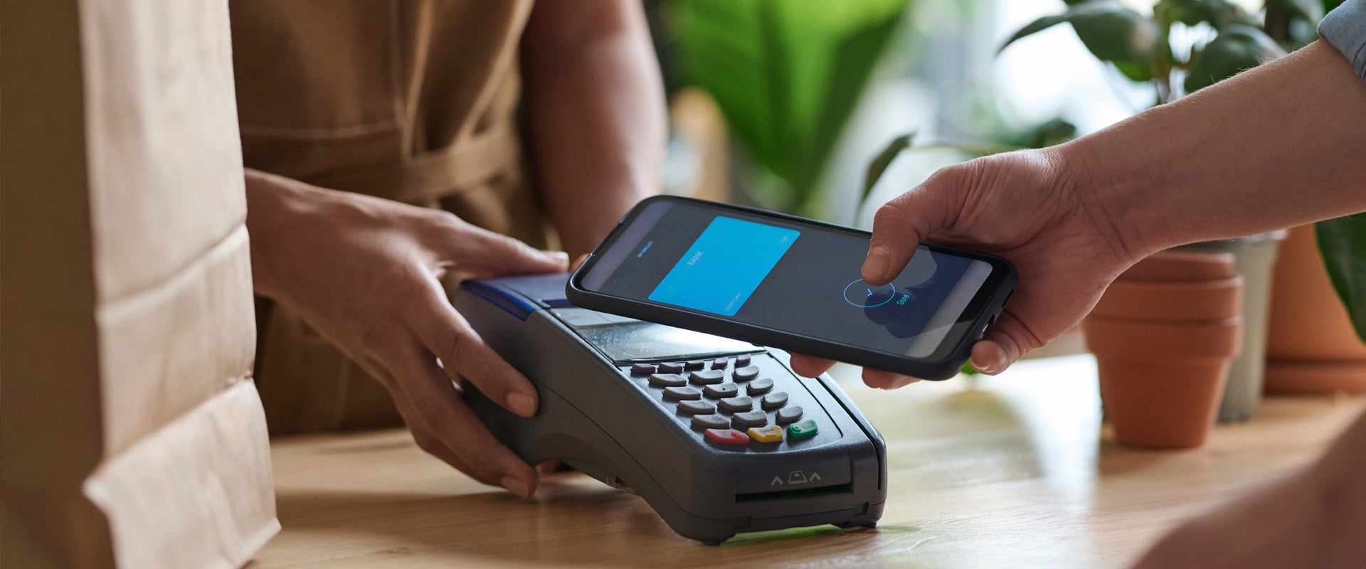 person makina purchase on mobile with pos