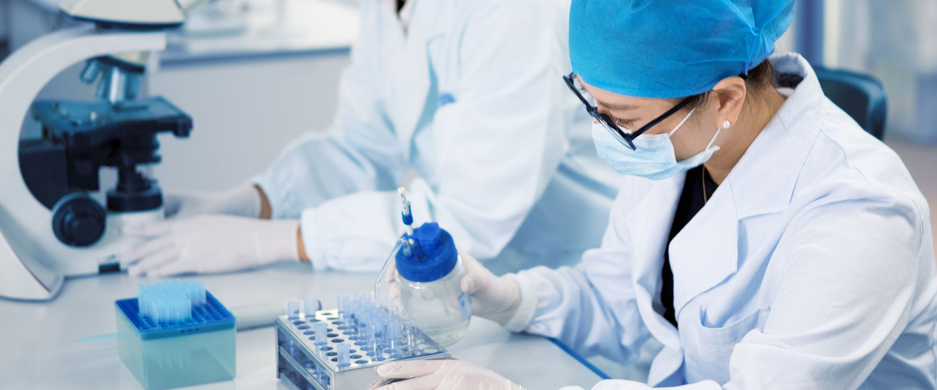 researcher pipetting liquids