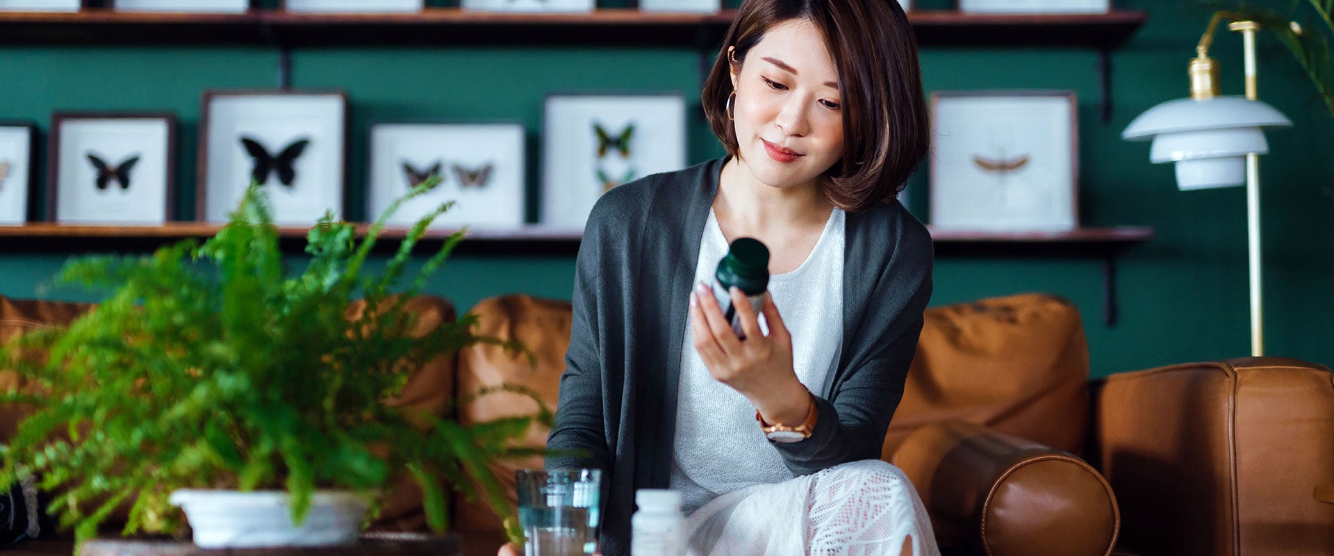 person holding vitamin bottle