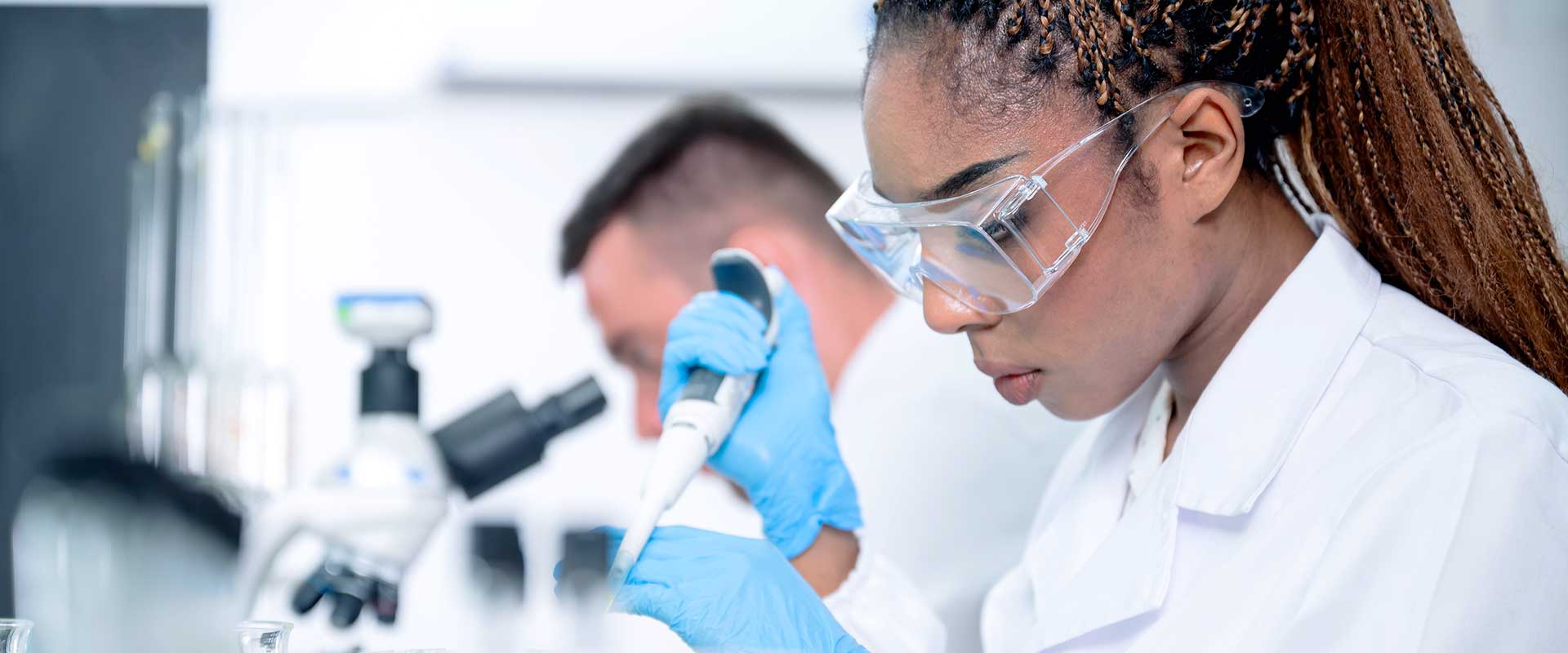 researcher pipetting in laboratory