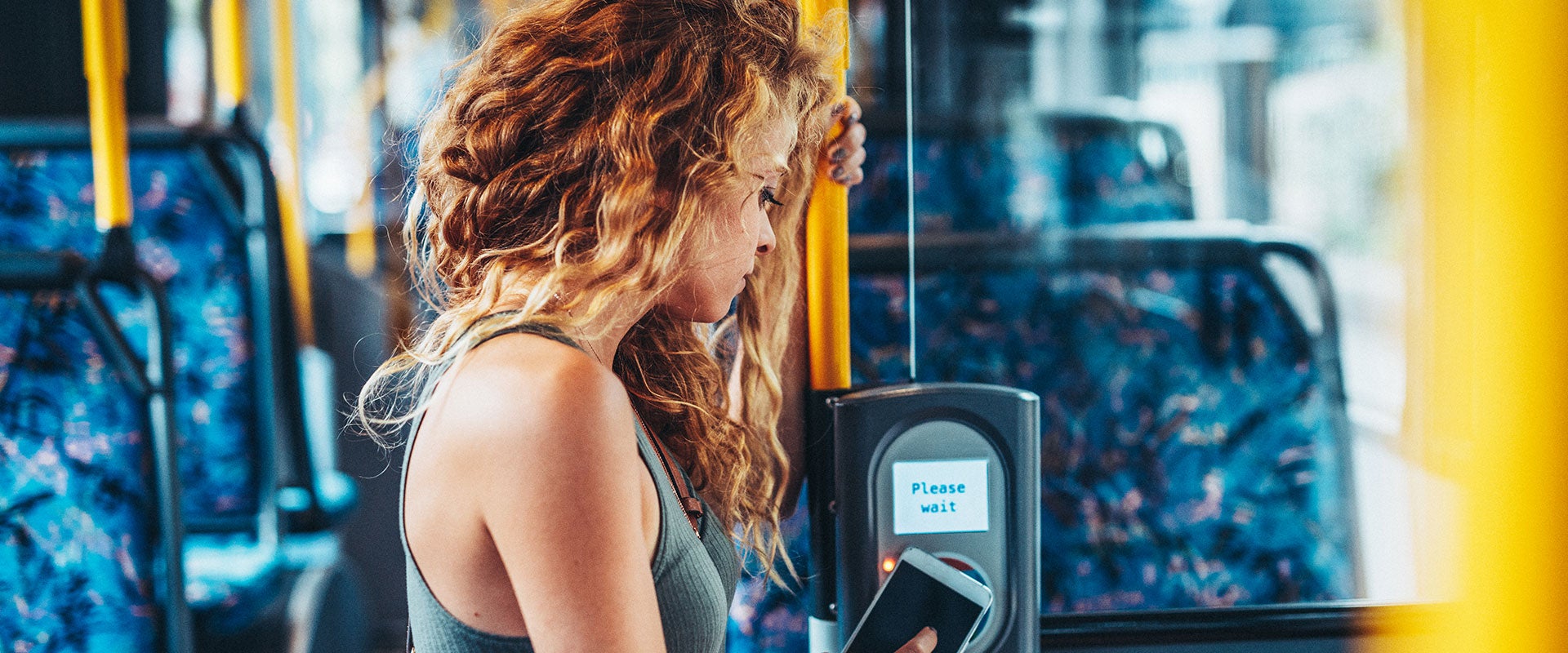Woman paying for bus ride with her phone