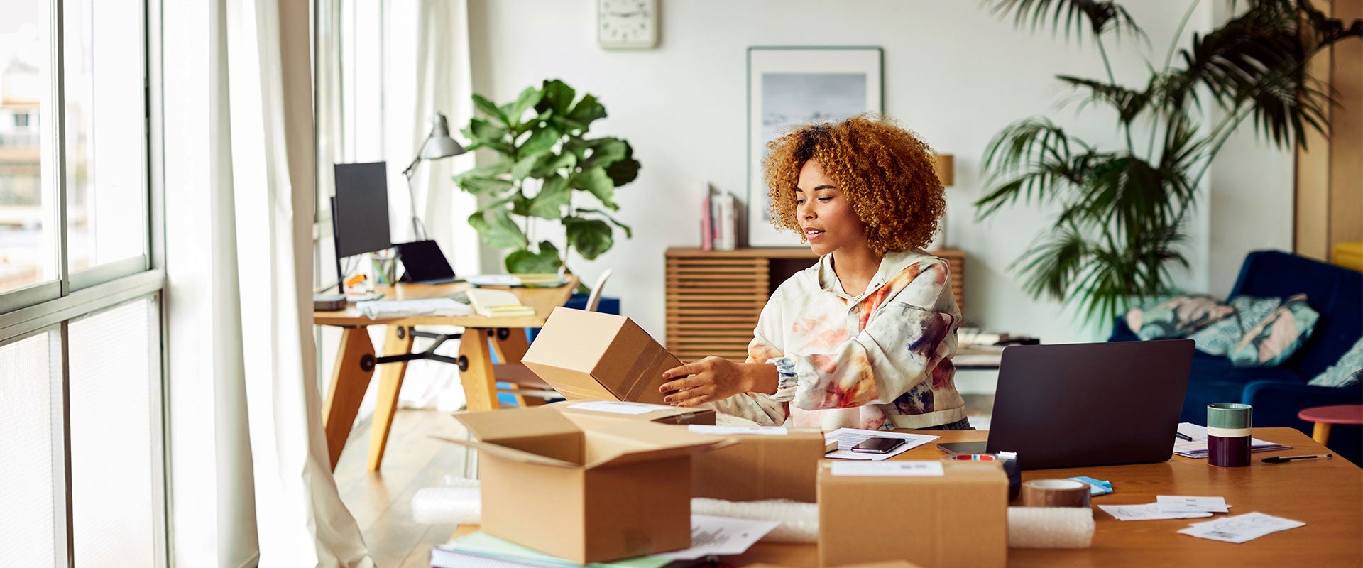 woman opening cardboard boxes