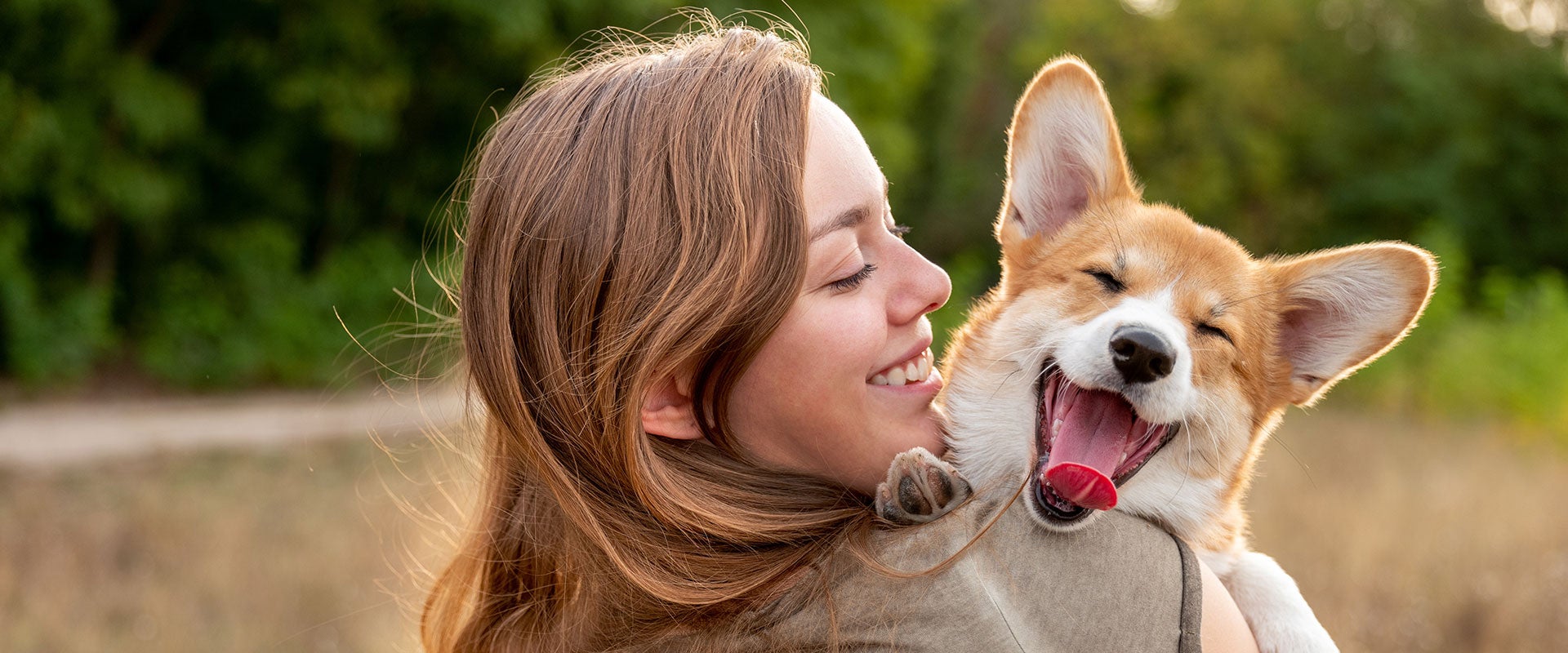 woman holding happy dog 