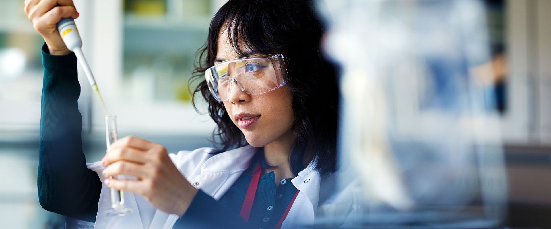 researcher pipetting liquid