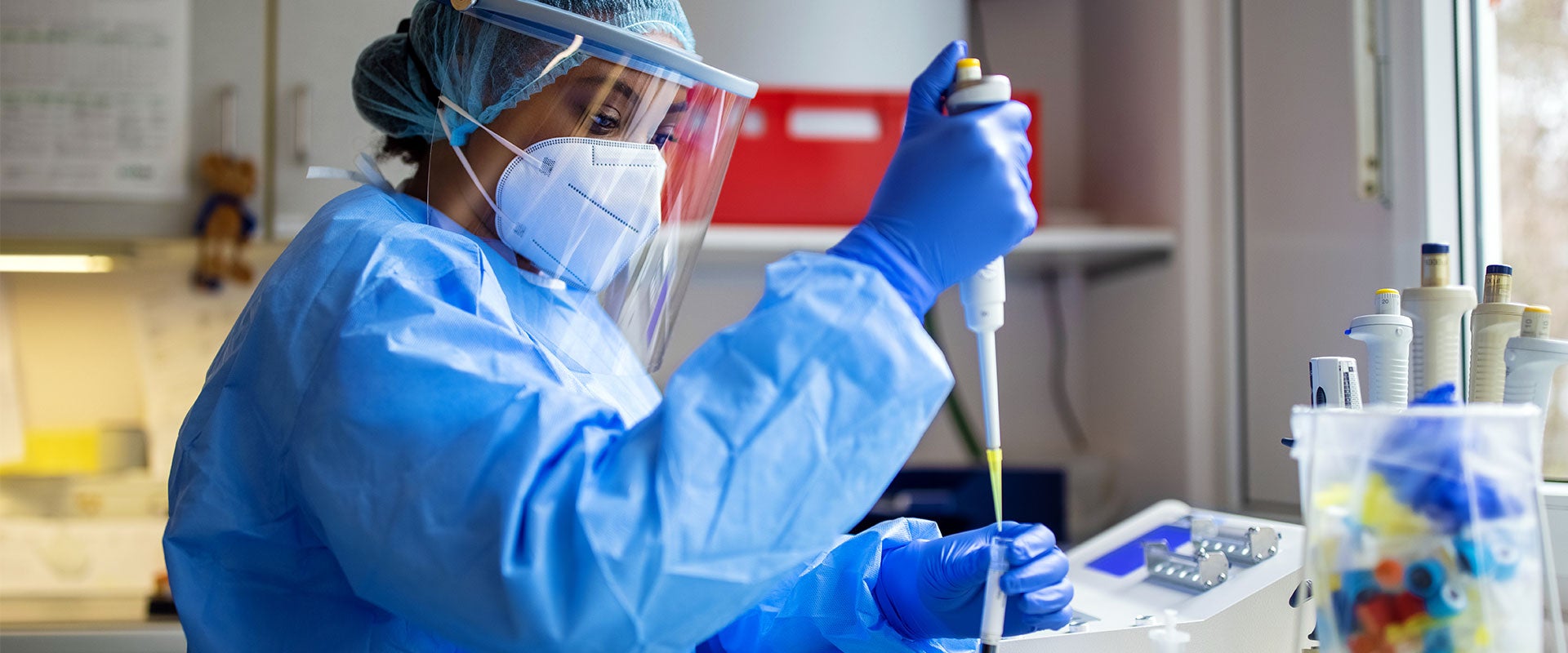 researcher pipetting liquids