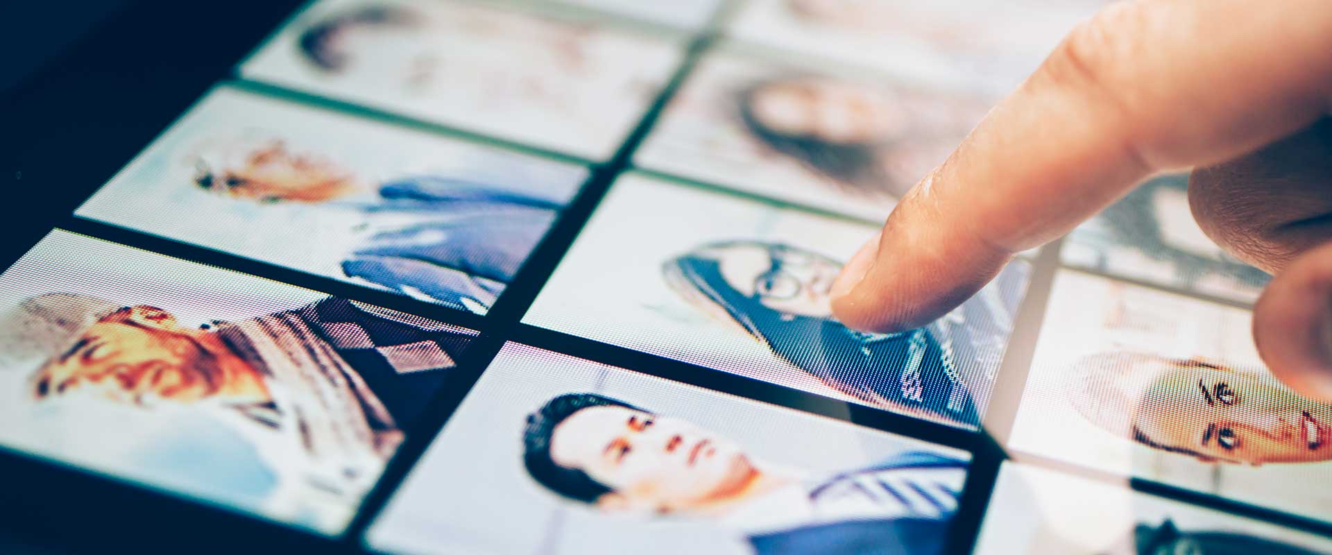 finger pointing at a grid of profile pictures