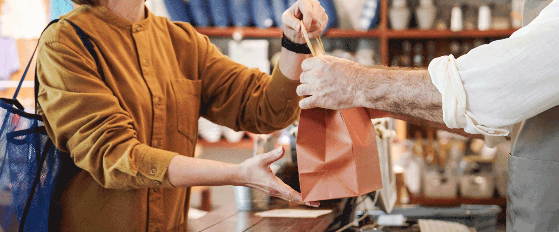 woman receiving purchase from storekeeper