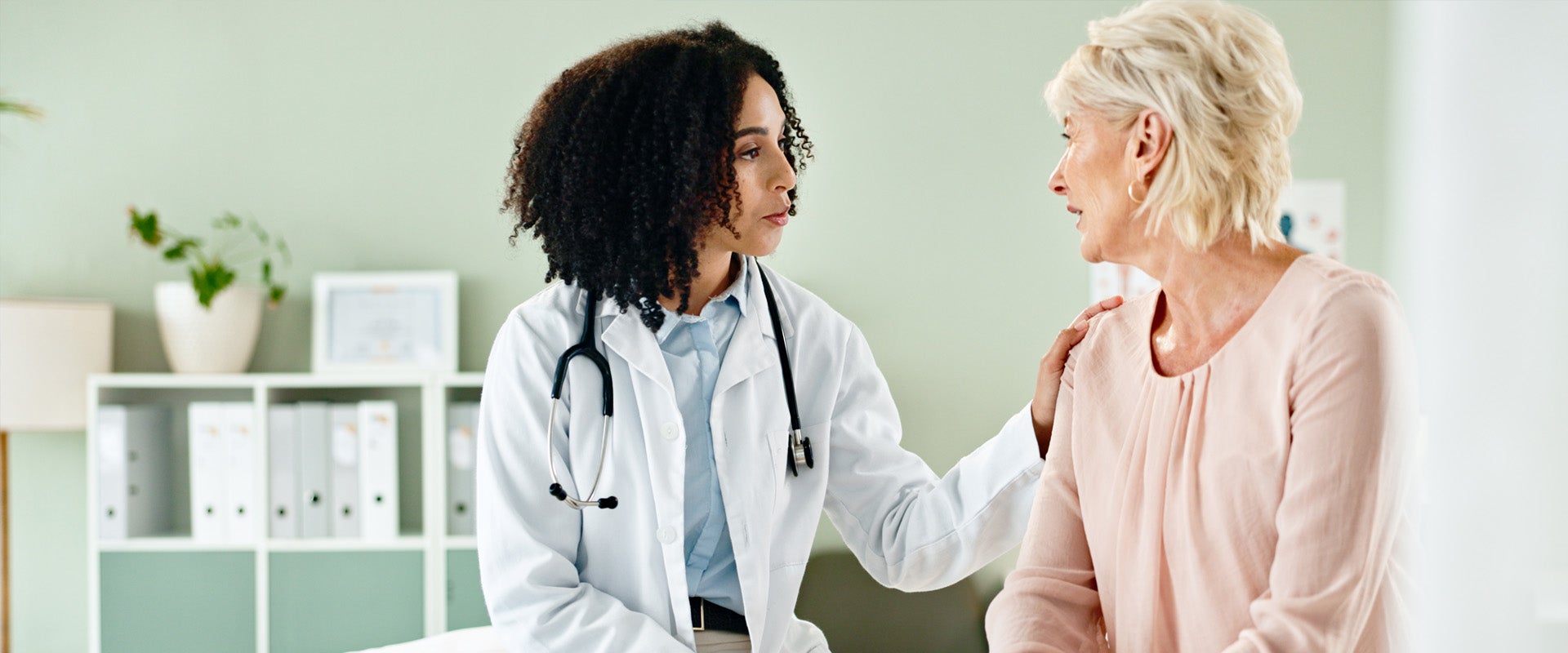 physician talking with patient in patient room