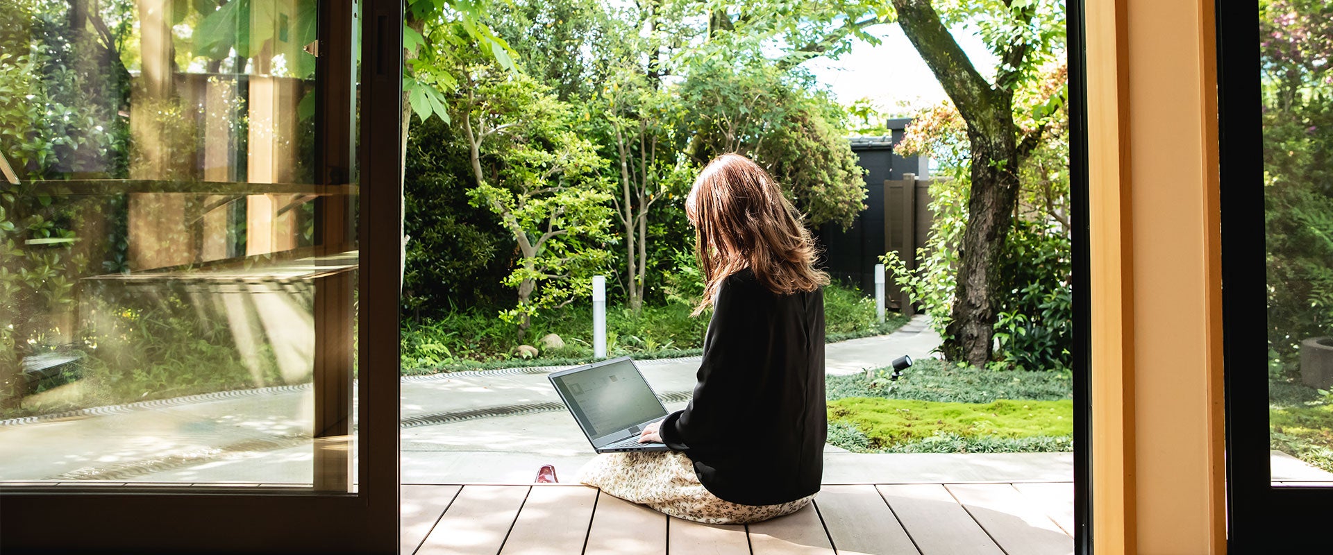 person using laptop on porch