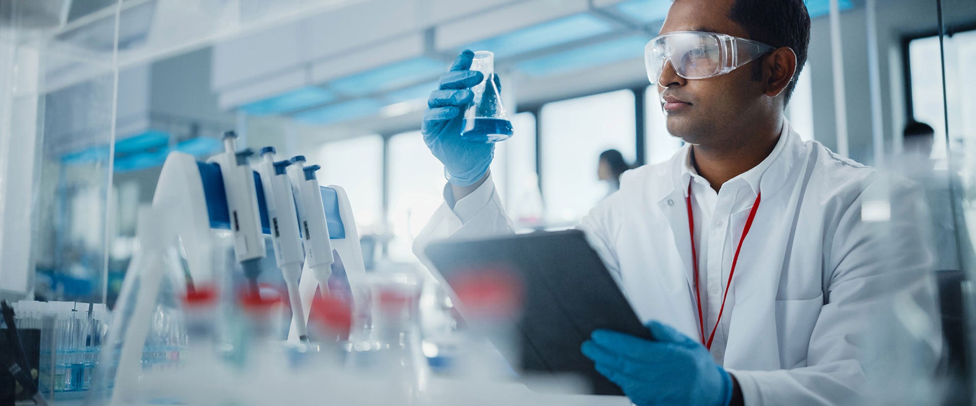 researcher holding vial