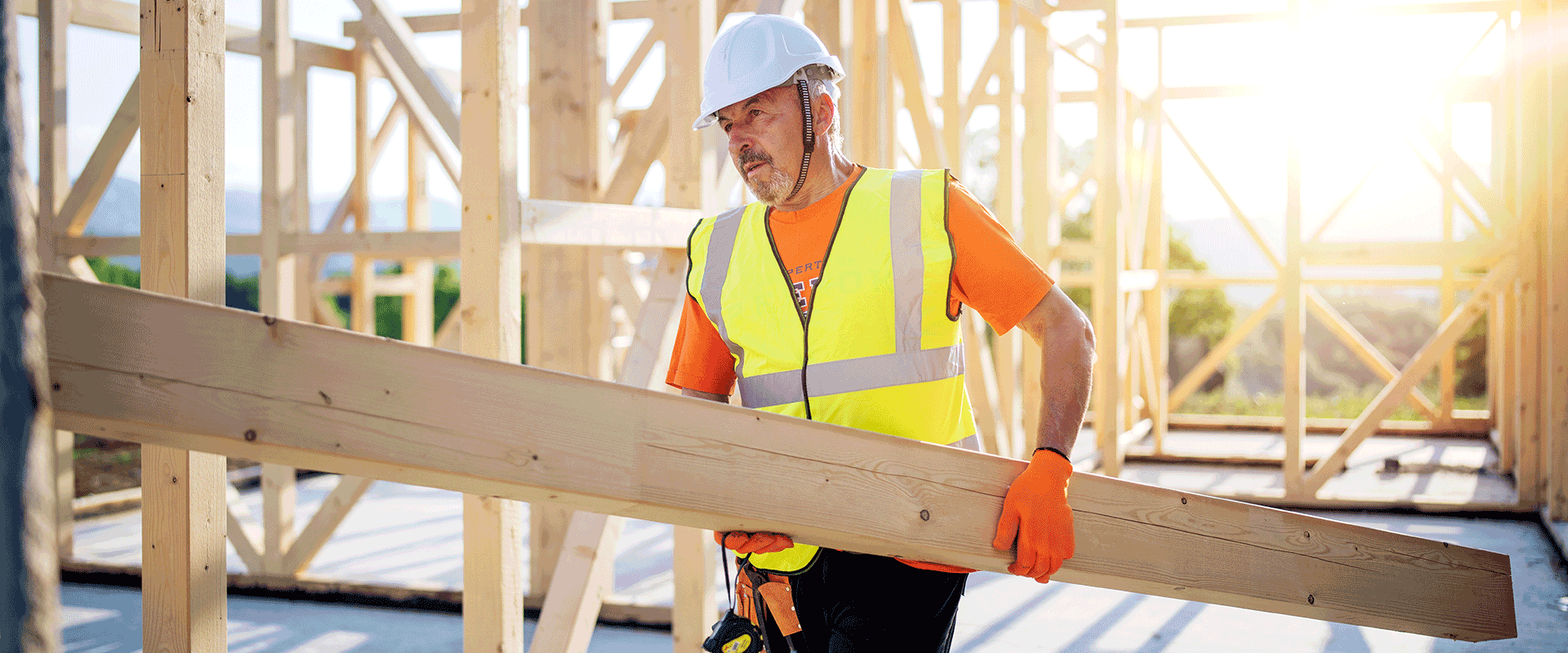 construction worker holding plank
