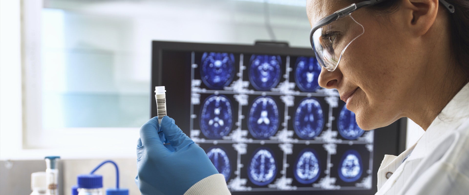 Lab researcher inspecting vial