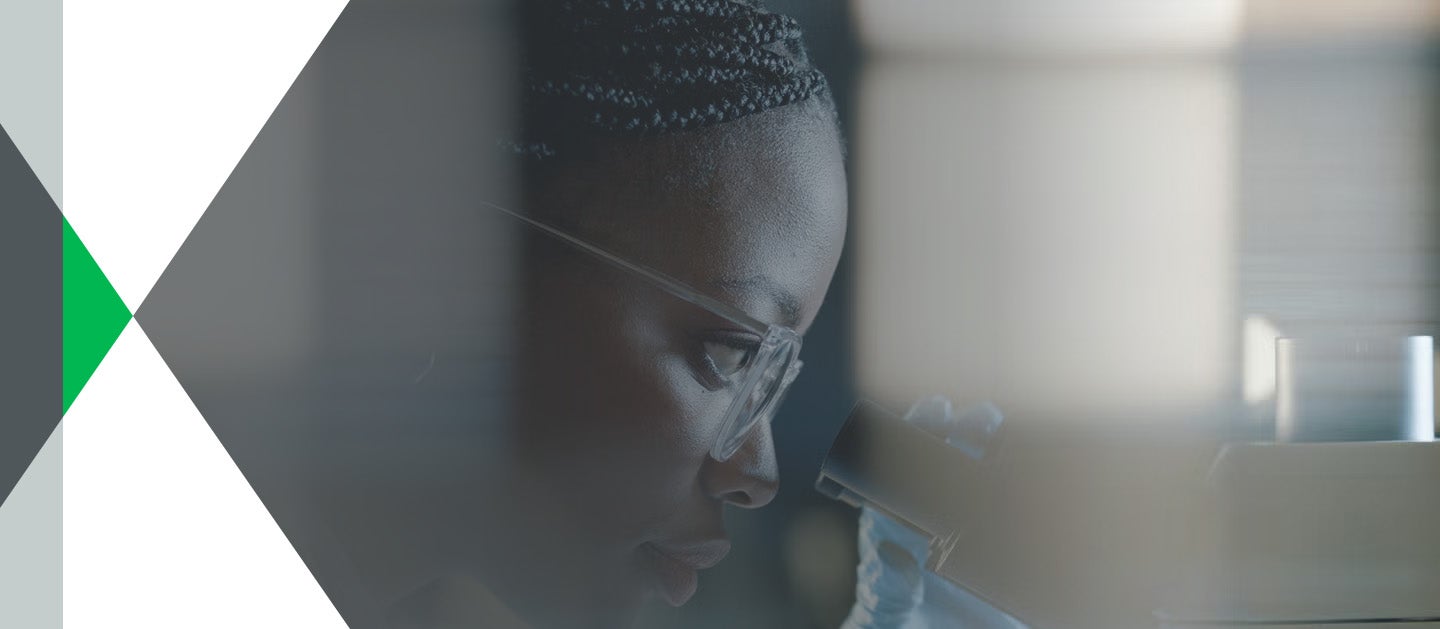 Researcher looking into microscope