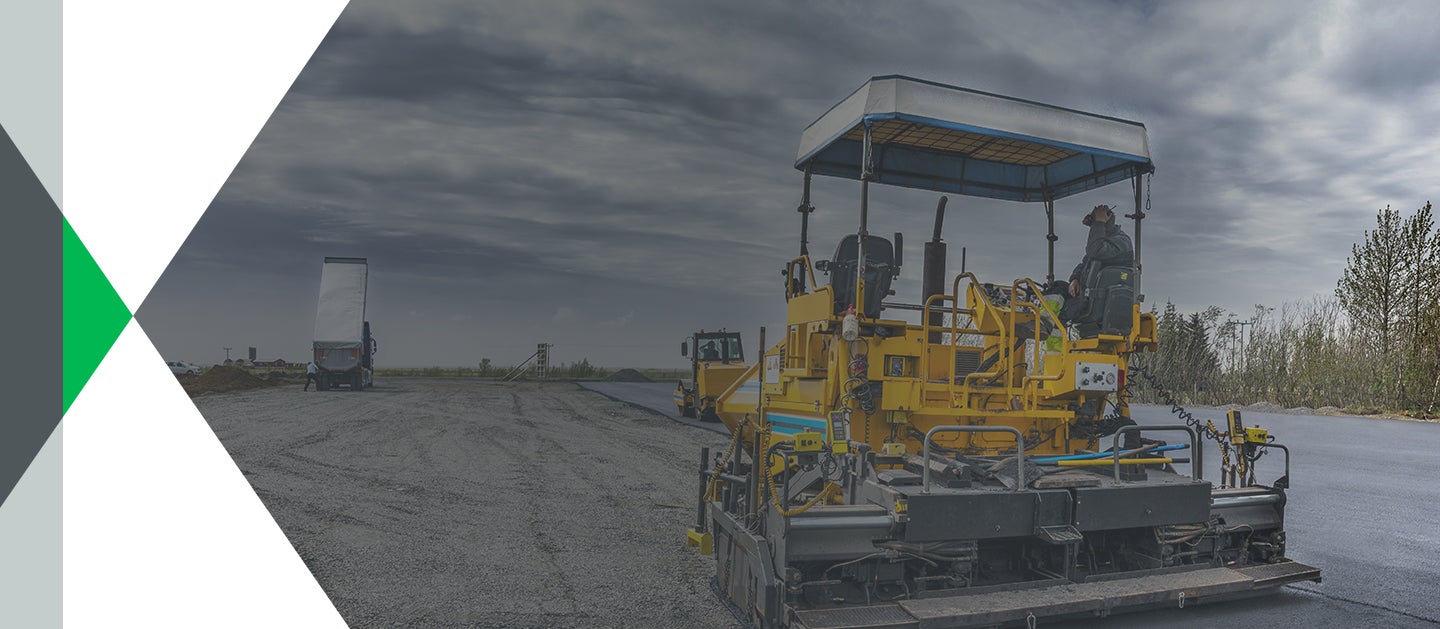 industrials worker using paver to create asphalt roads