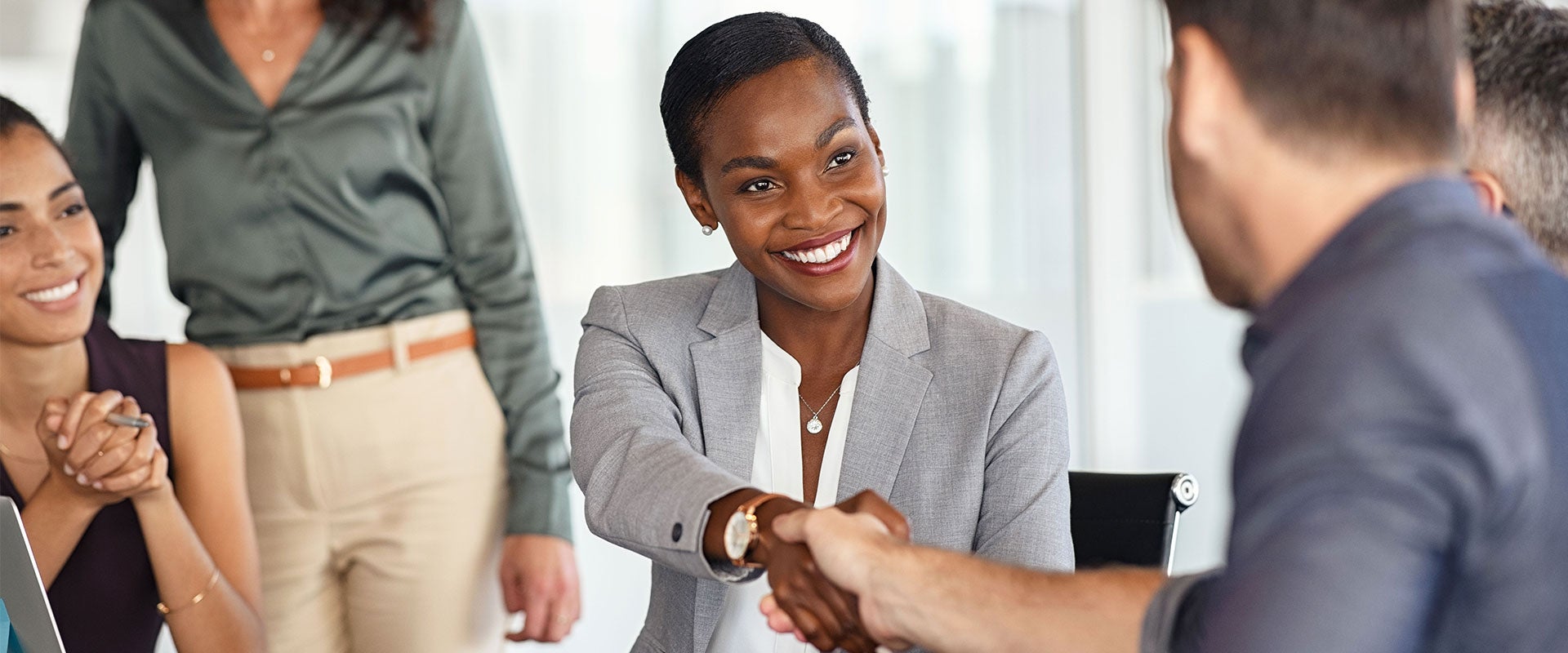 woman shaking person's hand