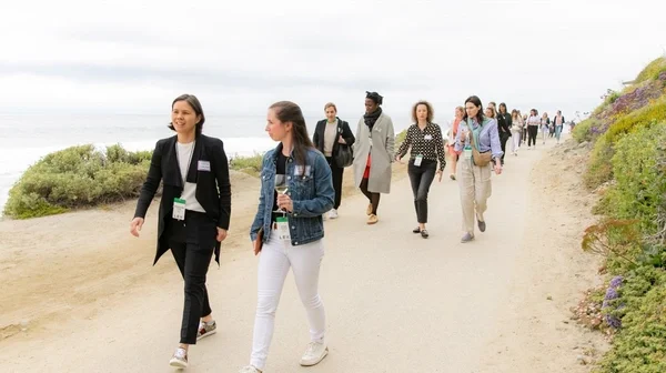 women walking along shore