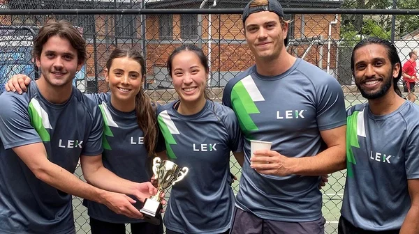 five smiling L.E.K. employees