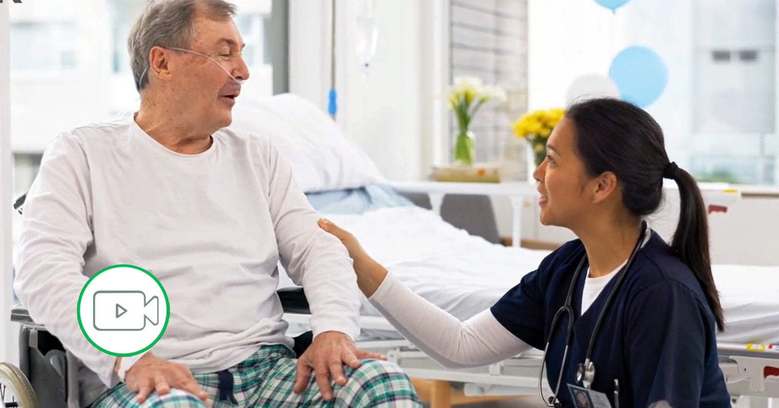 medical professional talking with patient in wheelchair