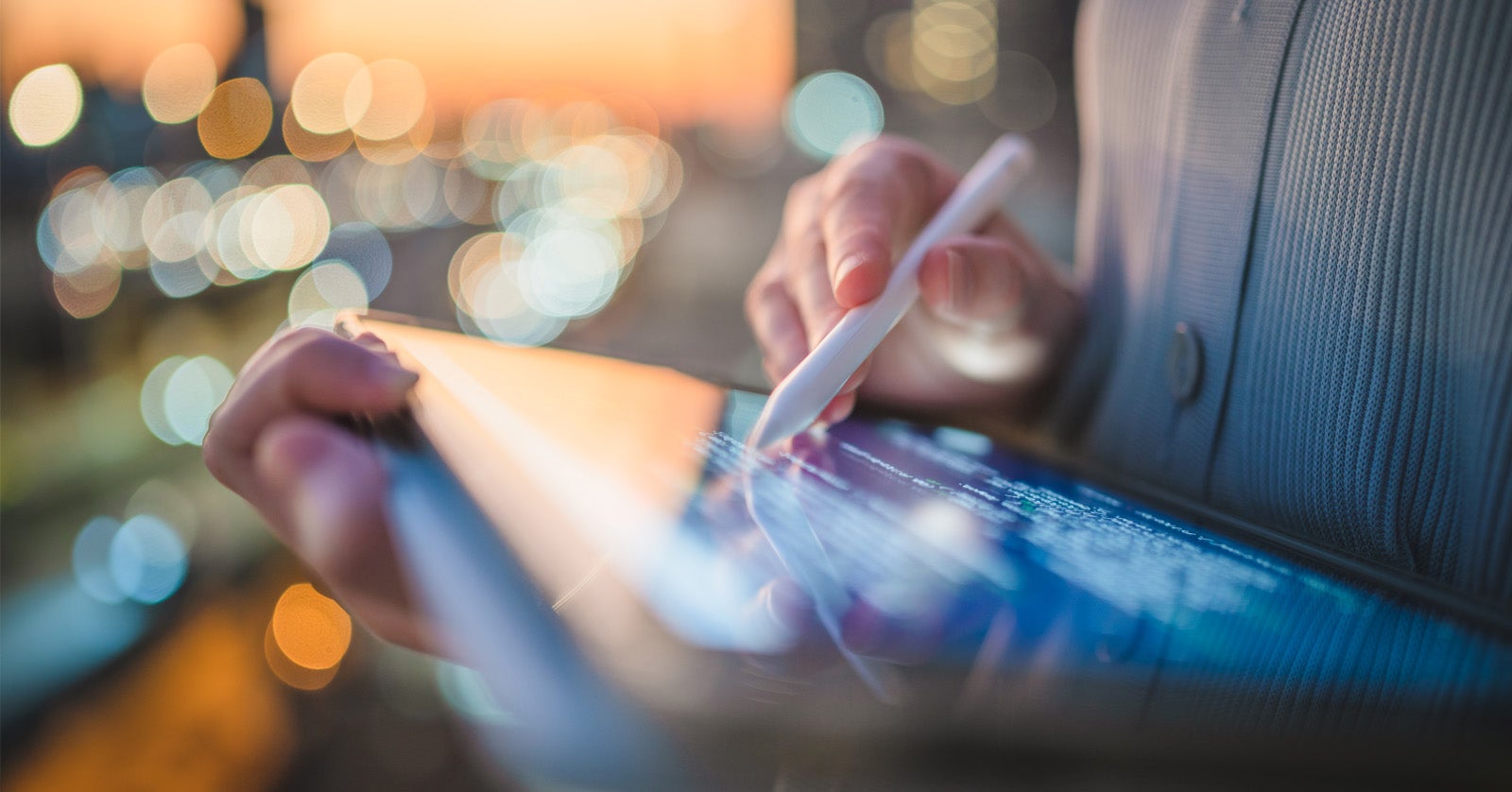person writing on tablet with stylus