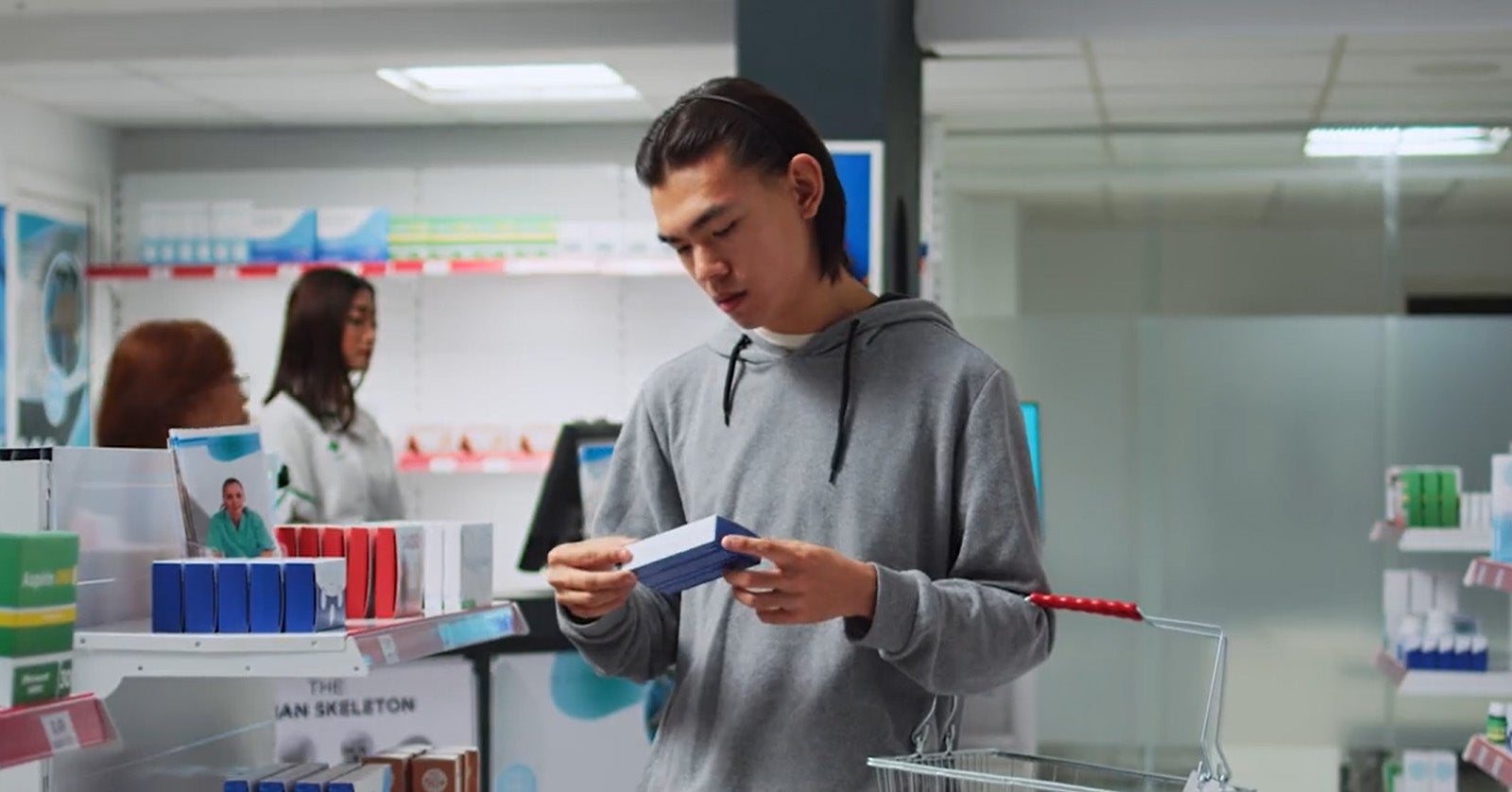 Man looking at medicine in pharmacy