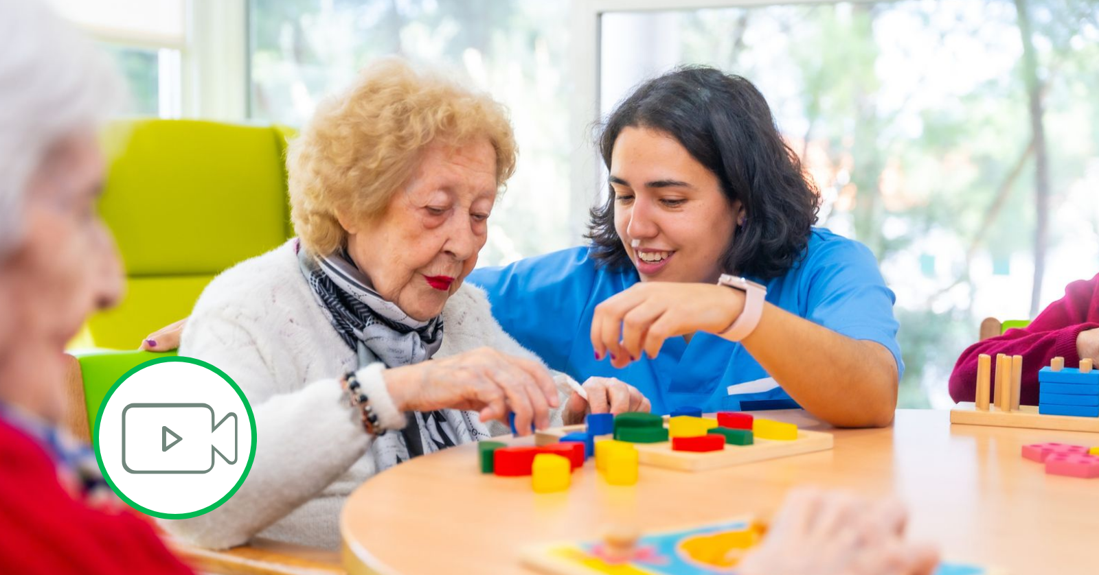 elderly woman with caretaker playing blocks