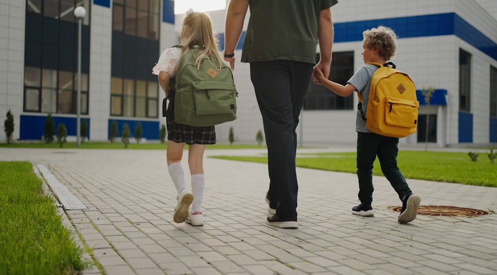 Kids walking to school with their caregiver